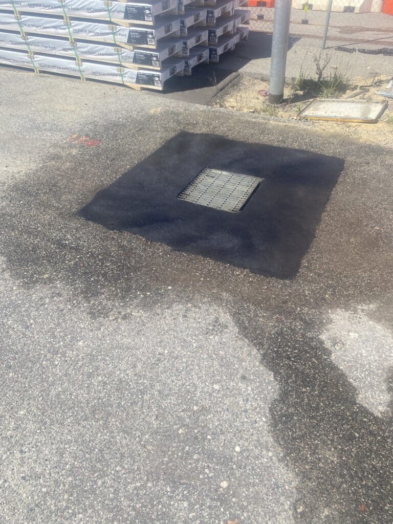 Soak Well with damaged asphalt removed and new asphalt installed, soak well asphalt repair