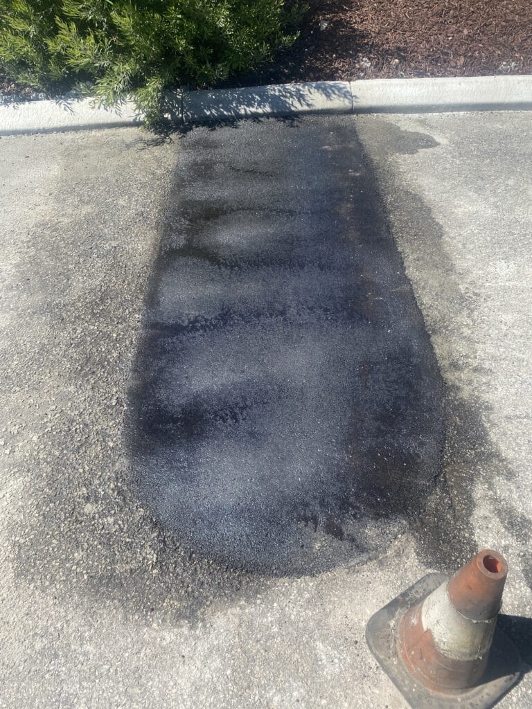Asphalt patch completed after the kerbing had been removed and replaced