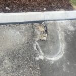 Asphalt Patch prior to repair after old kerbing had been removed and new kerbing installed
