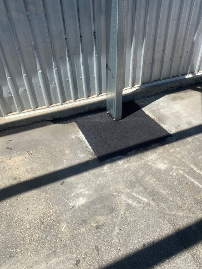 Asphalt patch repair to cover shed post footing, repair completed