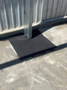 Asphalt patch cut and replace repair around a shed post