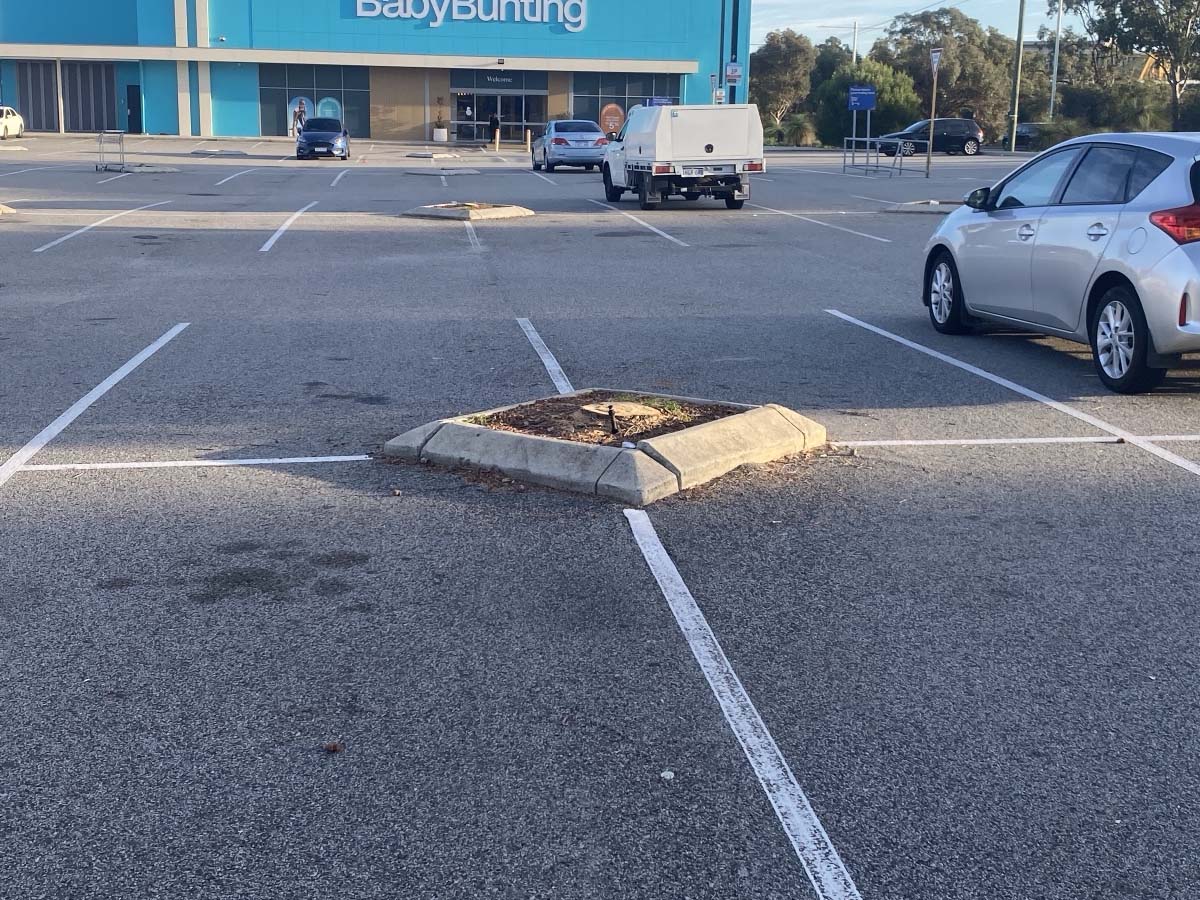 Before image of an asphalt patch repair in Joondalup, Western Australia for DB Complete Building Services.